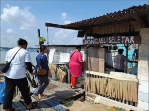 Entering a floating house in the village.